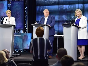 Ontario Liberal Leader Kathleen Wynne, left to right, Ontario Progressive Conservative Leader Doug Ford and Ontario NDP Leader Andrea Horwath listen to a question from an audience member as they participate during the third and final televised debate of the provincial election campaign in Toronto, Sunday, May 27, 2018.