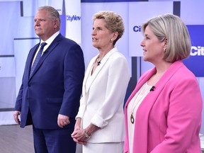 Liberal Premier Kathleen Wynne, centre, Progressive Conservative Leader Doug Ford, left, and NDP Leader Andrea Horwath stand together before the start of their debate in Toronto on Monday, May 7, 2018.