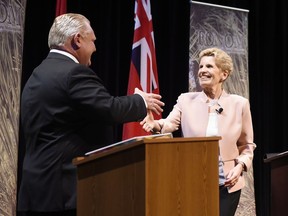 Ontario Progressive Conservative Leader Doug Ford, left, and Ontario Liberal Leader Kathleen Wynne shake hands after taking part in the second of three leaders' debate in Parry Sound, Ont., on Friday, May 11, 2018.