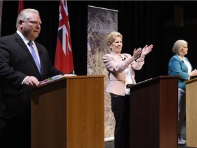 Ontario Progressive Conservative Leader Doug Ford, left to right, Ontario Liberal Leader Kathleen Wynne and Ontario NDP Leader Andrea Horwath applaud as they finish taking part in the second of three leaders' debate in Parry Sound, Ont., on Friday, May 11, 2018.