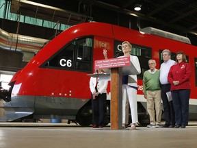 Ontario Liberal leader Kathleen Wynne speaks in front of an O-Train at a campaign stop in Ottawa on Thursday, May 17, 2018.