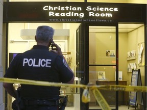 Ottawa police stand in front of 141c Laurier Ave in Ottawa on Thursday May 24, 2018  after a woman was found bloodied and beaten inside the office at the Christian Science Reading Room. Tony Caldwell