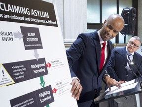 Ahmed Hussen, Minister of Immigration, Refugees and Citizenship, discusses the situation of irregular migration as Ralph Goodale, Minister of Public Safety and Emergency Preparedness, looks on Monday, May 7, 2018 in Montreal.