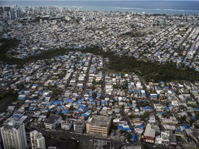 Damaged roofs are covered with blue tarps in San Juan, Puerto Rico, on Feb. 2, 2018. Next month will be the start of this year's hurricane season, and Puerto Ricans still reeling from the damage of Hurricane Maria, are worried.