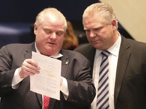 Mayor Rob Ford with his brother councillor Doug Ford as Toronto City Council debates the budget on Thursday, January 30, 2014.