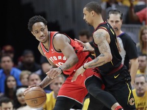 Toronto Raptors' DeMar DeRozan attempts to drive on Cleveland Cavaliers' George Hill in the first half of Game 4 of an NBA basketball second-round playoff series, Monday, May 7, 2018, in Cleveland.