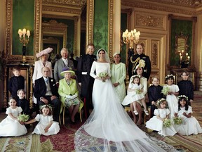 A photo released by Kensington Palace on May 21, 2018 shows Prince Harry, Duke of Sussex, (CL) and his wife Meghan, Duchess of Sussex, (CR) posing for an official wedding photograph with (L-R back row) Britain's Camilla, Duchess of Cornwall, Britain's Prince Charles, Prince of Wales, Doria Ragland, the Duchess of Sussex's mother, Britain's Prince William, Duke of Cambridge, (middle row L-R): Master Jasper Dyer, Britain's Prince Philip, Duke of Edinburgh, Britain's Queen Elizabeth II, Britain's Catherine, Duchess of Cambridge, Princess Charlotte of Cambridge, Prince George of Cambridge, Miss Rylan Litt, Master John Mulroney and (front row) Miss Ivy Mulroney, Master Brian Mulroney, Miss Florence van Cutsem, Miss Zalie Warren and Miss Remi Litt in the Green Drawing Room, Windsor Castle, in Windsor on May 19, 2018.