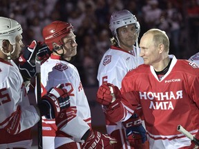 Russian President Vladimir Putin, right, takes part in a match of the Night Hockey League teams in the Bolshoy Ice Arena in the Black Sea resort of Sochi, Russia, Thursday, May 10, 2018.