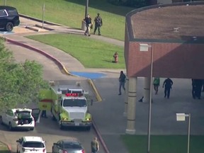In this image taken from video law enforcement officers respond to a high school near Houston after an active shooter was reported on campus, Friday, May 18, 2018, in Santa Fe, Texas.