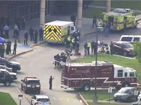 In this image taken from video emergency personnel and law enforcement officers respond to a high school near Houston after an active shooter was reported on campus, Friday, May 18, 2018, in Santa Fe, Texas.