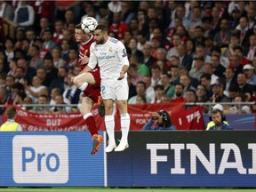 Liverpool's Andy Robertson, left, jumps for the ball with Real Madrid's Dani Carvajal during the Champions League Final soccer match at the Olimpiyskiy Stadium in Kyiv, Ukraine, Saturday, May 26, 2018. Top Canadian soccer officials were at Saturday's Champions League final in Kyiv, mixing business with pleasure as they pressed their case for the so-called unified 2026 World Cup bid.