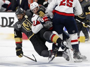 Vegas Golden Knights left wing Pierre-Edouard Bellemare, left, of France, takes Washington Capitals center Jay Beagle down during the second period in Game 1 of the NHL hockey Stanley Cup Finals, Monday, May 28, 2018, in Las Vegas.