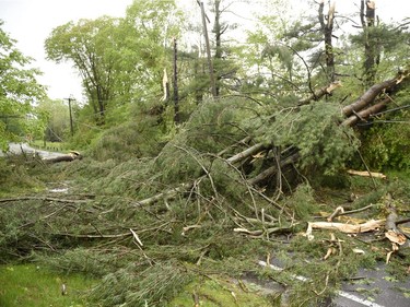 Downed trees and power lines block Main Street South in Bridgewater, Conn.,  after severe storms rolled through the area Tuesday, May 15, 2018.Residents in the Northeast cleaned up Wednesday, a day after powerful storms pounded the region with torrential rain and marble-sized hail, leaving more 200,000 homes and businesses without power.  (John Woike/Hartford Courant via AP) ORG XMIT: CTHAR104