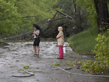 Two women look at the storm damage in Bridgewater, Conn.,  Tuesday, May 15, 2018. after severe storms rolled through the area.  Residents in the Northeast cleaned up Wednesday, a day after powerful storms pounded the region with torrential rain and marble-sized hail, leaving more then 200,000 homes and businesses without power.  (John Woike/Hartford Courant via AP) ORG XMIT: CTHAR102