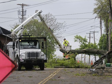 A utility crew works to clear a roadway of storm debris in Newburgh, N.Y., Wednesday, May 16, 2018. Powerful storms pounded the Northeast on Tuesday with torrential rain and marble-sized hail, leaving thousands of homes and businesses without power.