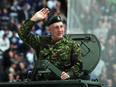 Former Toronto Maple Leaf Dave 'Tiger' Williams salutes the crowd on military honour night before a game in Toronto on March 16, 2013.