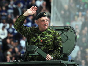 Former Toronto Maple Leaf Dave 'Tiger' Williams salutes the crowd on military honour night before a game in Toronto on March 16, 2013.