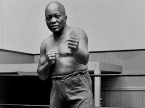 FILE - In this 1932 file photo, boxer Jack Johnson, the first black world heavyweight champion, poses in New York City. President Donald Trump on Thursday, May 24, 2018, granted a rare posthumous pardon to boxing's first black heavyweight champion, clearing Jack Johnson's name more than 100 years after a racially-charged conviction.