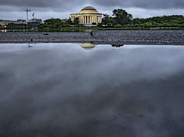 Storm clouds are reflected in a puddle near the Jefferson Memorial in Washington, Wednesday, May 16, 2018. Rain and thunderstorms are expected to continue in the Nation's Capital area for the next couple of day.