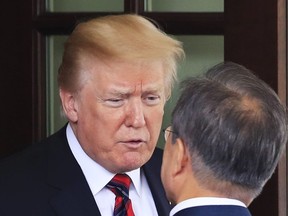 President Donald Trump talks to visiting South Korean President Moon Jae-in as he departs the White House in Washington, Tuesday, May 22, 2018.