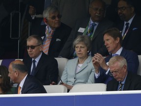 Britain's Prime Minister Theresa May, centre watches from the stands during the second day of play of the first test cricket match between England and Pakistan at Lord's cricket ground in London, Friday, May 25, 2018.