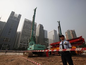 In this Oct. 26, 2009 file photo, security workers guard at construction site of the U.S. Consulate compound in Guangzhou in southern China's Guangdong province.
