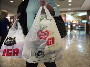 Montreal implemented its long-planned ban on plastic bags on Monday, making it the first major Canadian city to do so. A woman leaves a grocery store in Montreal, Friday, May 15, 2015.