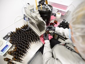 Workers package cannabis oil at Canopy Growth Corporation's Tweed facility in Smiths Falls, Ont., on Monday, Feb. 12, 2018.