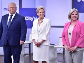 Party leaders Doug Ford, left, Kathleen Wynne and Andrea Horwath stand together for a photo before a televised debate on May 7.