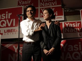 Liberal MPP Yasir Naqvi gives a speech at the Carleton Tavern with his wife Christine McMillan after losing the Ottawa Centre riding to the NDP's Joel Harden, in Ottawa on June 7, 2018.