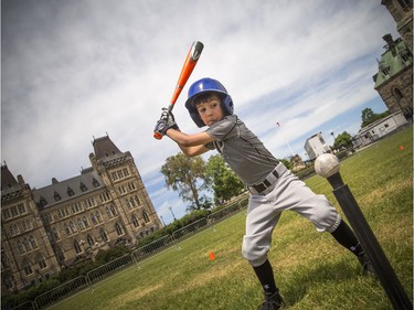 National Little League week kicked off with two teams coming together for a game of T-Ball on the lawn of Parliament Hill Sunday June 10, 2018. Six-year-old Dawson Aucoin winds up to take a swing Sunday afternoon.   Ashley Fraser/Postmedia