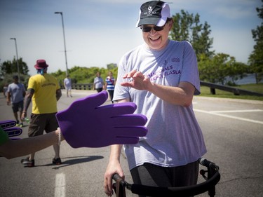 The annual 5 km "WALK for ALS" took place at the Canadian War Museum in support of those living with Amyotrophic Lateral Sclerosis (ALS), commonly known as Lou Gehrig's disease, Saturday June 9, 2018. This year's lead walker Mike Rannie, who was diagnosed with ALS just over one year ago at the age of 53, gets a high five as he comes into the finish line Saturday.