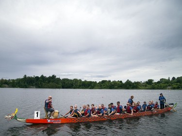 Team Gung Ho makes its way down the river to the start line Saturday.