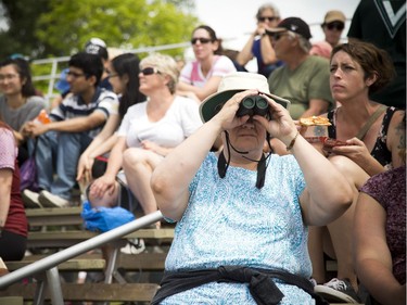 Spectators watch the races at the 25th Annual Tim Hortons Ottawa Dragon Boat Festival at Mooney's Bay Park on the Rideau River Sunday June 24, 2018.