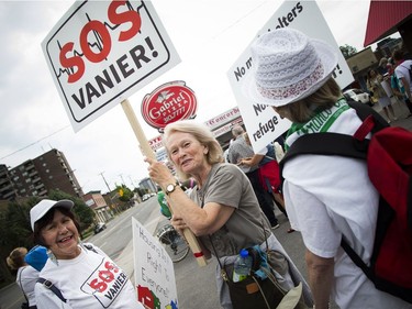 Residents opposed to the Salvation Army's plans for a new shelter and facility in Vanier took their message to the streets, marching through their community Sunday June 24, 2018. L-R Shirley Ruda and Clodie Paris who both live nearby, say "its our village" and they wanted to come out to support it.