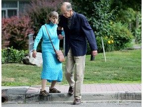 Nicole Woinarosky, 64,  gets help from her husband, Allan Gordon, stepping off the pavement near their Ottawa apartment.