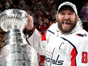 Washington Capitals captain Alex Ovechkin is handed the Stanley Cup on June 7, 2018.