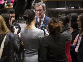 Ottawa Mayor Jim Watson speaks with members of the media following a recent council meeting.