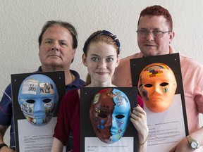 Brain trauma survivors Jack Berry, left, Katelyn-Marie Irvine and Murray MacDonald with the masks they made to artistically represent their personal journeys.
