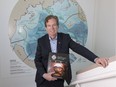 John Geiger, CEO of the Royal Canadian Geographic Society, with the Indigenous Peoples Atlas of Canada.