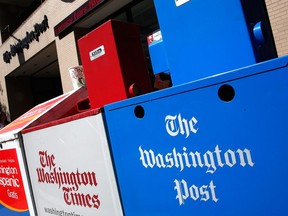 Newspaper boxes stand outside the Washington Post building September 2, 2014 in Washington, DC.
