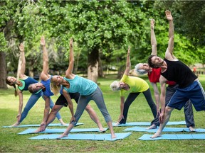 Fitness class stretching in the park.