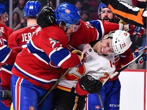 Alex Galchenyuk battles it out with Garnet Hathaway during a Canadiens-Flames game in Montreal on Dec. 7.