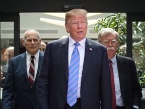 US President Donald Trump (C) leaves with Chief of Staff John Kelly (L) and National Security Advisor John Bolton (R) after holding a press conference ahead of his early departure from the G7 Summit on June 9, 2018 in La Malbaie, Canada. Canada are hosting the leaders of the UK, Italy, the US, France, Germany and Japan for the two day summit, in the town of La Malbaie.