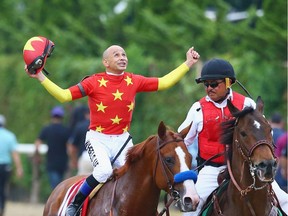 Jockey Mike Smith celebrates atop of Justify after winning the Belmont Stakes to become only the 13th Triple Crown winner and the first since American Pharoah in 2015.