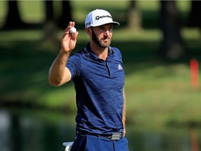 Dustin Johnson waves to the gallery after hitting his second shot for eagle on the 18th hole during the final round of the FedEx St. Jude Classic at TPC Southwind on June 10, 2018 in Memphis, Tennessee.