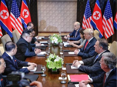 SINGAPORE, SINGAPORE - JUNE 12:  In this handout photograph provided by The Strait Times, North Korean leader Kim Jong-un (L) with U.S. President Donald Trump (R) during their historic U.S.-DPRK summit at the Capella Hotel on Sentosa island on June 12, 2018 in Singapore. U.S. President Trump and North Korean leader Kim Jong-un held the historic meeting between leaders of both countries on Tuesday morning in Singapore, carrying hopes to end decades of hostility and the threat of North Korea's nuclear programme.