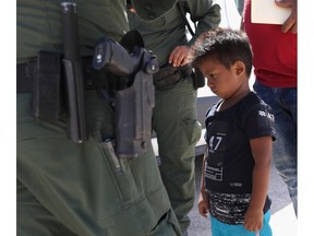 A boy and father from Honduras are taken into custody by U.S. Border Patrol agents near the U.S.-Mexico Border on June 12, 2018 near Mission, Texas. The asylum seekers were then sent to a U.S. Customs and Border Protection (CBP) processing center for possible separation. U.S. border authorities are executing the Trump administration's "zero tolerance" policy towards undocumented immigrants. U.S. Attorney General Jeff Sessions also said that domestic and gang violence in immigrants' country of origin would no longer qualify them for political asylum status.