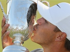 Brooks Koepka of the United States celebrates with the U.S. Open Championship trophy after winning the 2018 U.S. Open at Shinnecock Hills Golf Club on June 17, 2018 in Southampton, New York.
