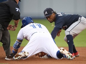 Kevin Pillar #11 of the Toronto Blue Jays slides safely into second base with a double in the fourth inning during MLB game action as Ozzie Albies #1 of the Atlanta Braves tries to tag him out at Rogers Centre on June 19, 2018 in Toronto.